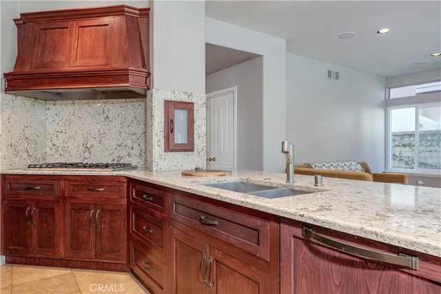 a kitchen with granite countertop cabinets stainless steel appliances and wooden cabinets