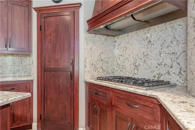 a kitchen with kitchen island granite countertop wooden cabinets and a granite counter tops
