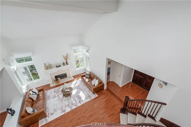 a living room with furniture a clock and a window