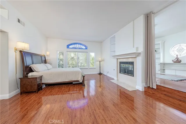 a bathroom with a sink vanity granite tub and a large mirror