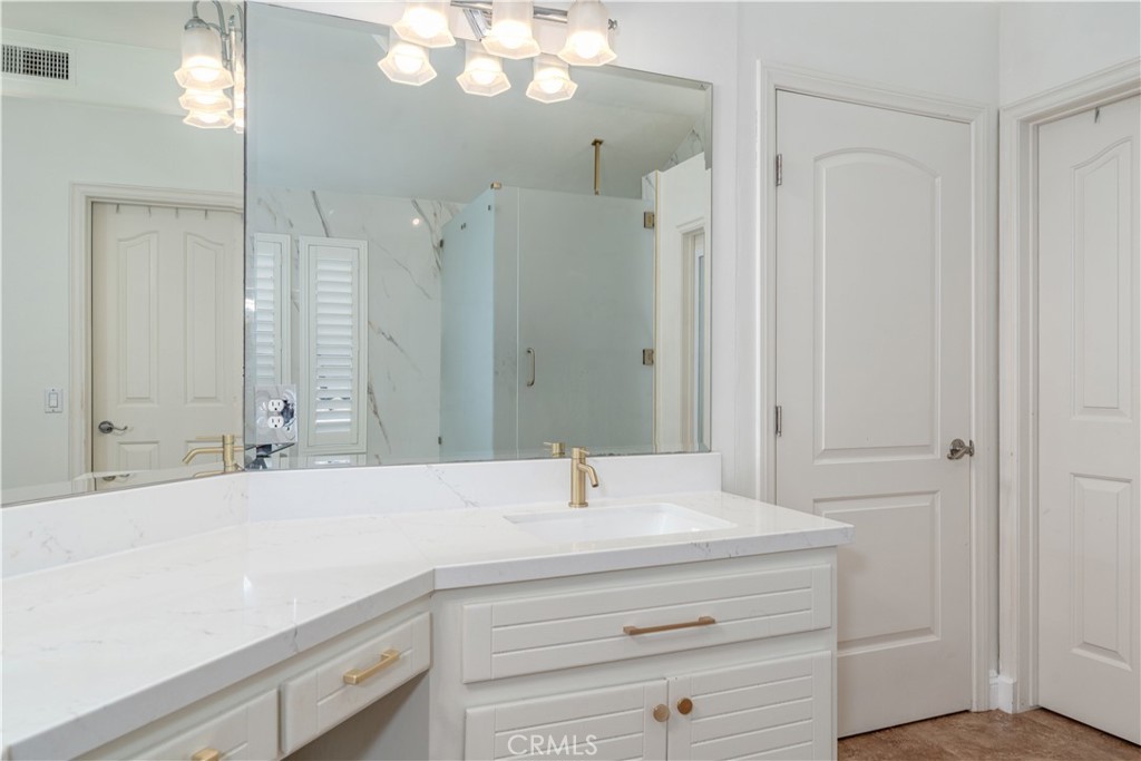 9574 Tivoli Circle Cypress, CA 90630 - Photo 32 of 68 a bathroom with a sink vanity and a mirror