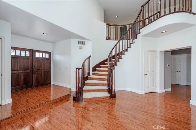 a living room with furniture a fireplace and a large mirror