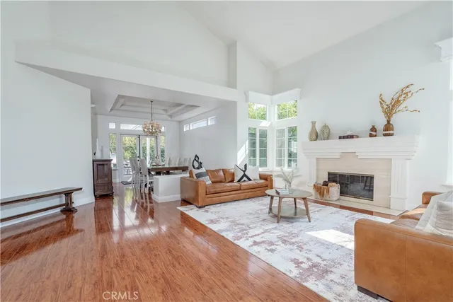 a dining room with furniture a large window and wooden floor