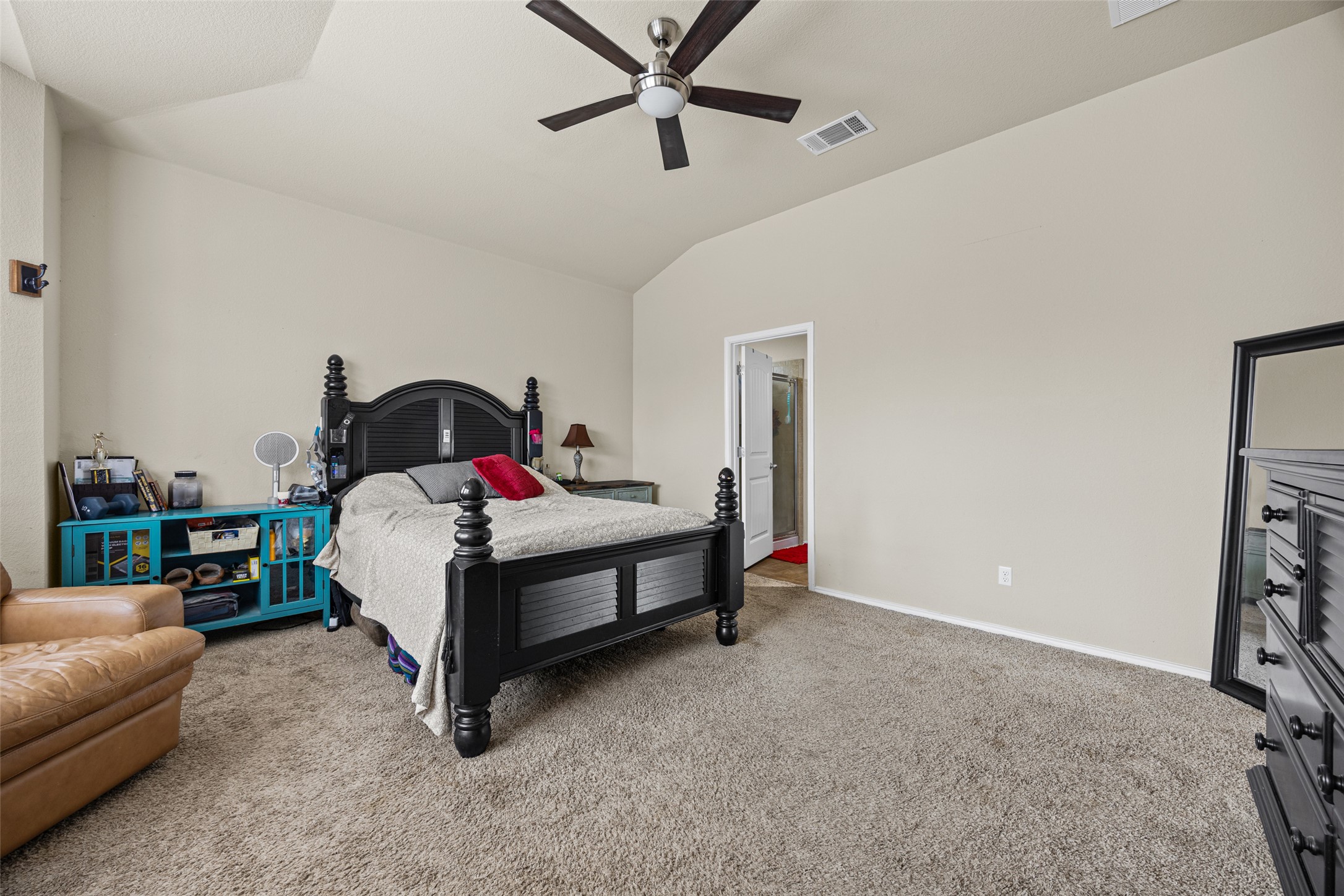 19113 Rookery Trail Pflugerville, TX 78660 - Photo 21 of 36 Spacious bedroom featuring vaulted ceilings and neutral wall tones