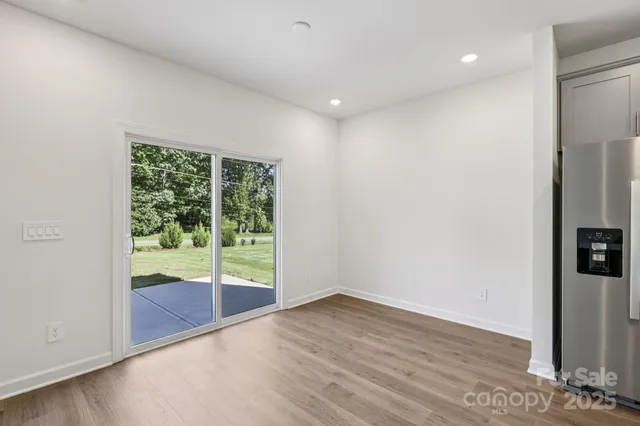 an empty room with wooden floor and a window