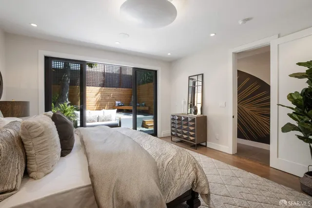 a bedroom with a large bed and a balcony