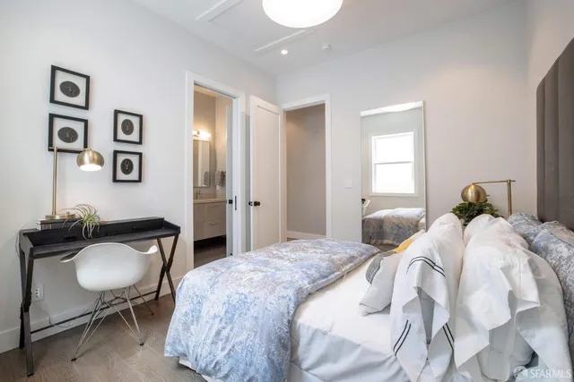 a bedroom with a bed and a chair