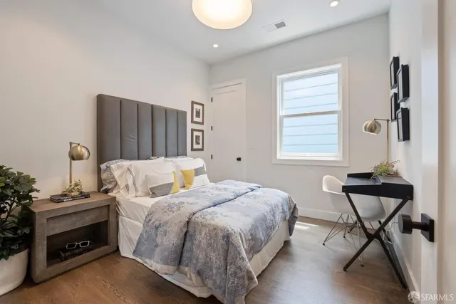 a bedroom with a bed and a chair