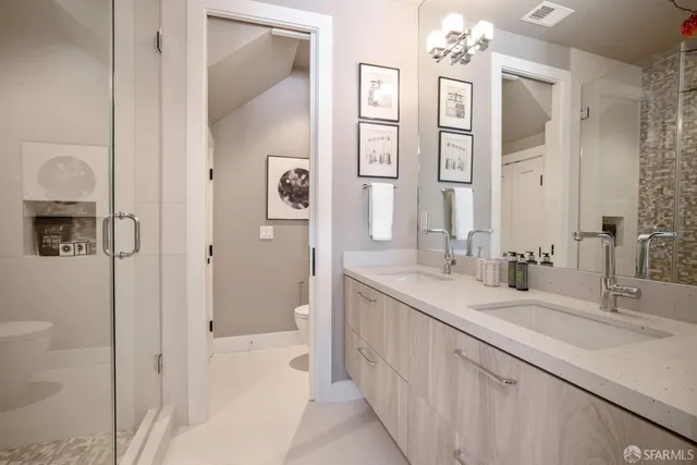 a bathroom with a double vanity sink shower and a mirror