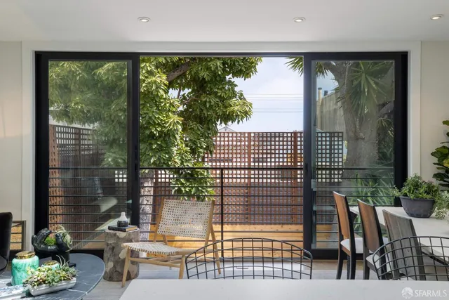 a view of a porch with chairs and backyard