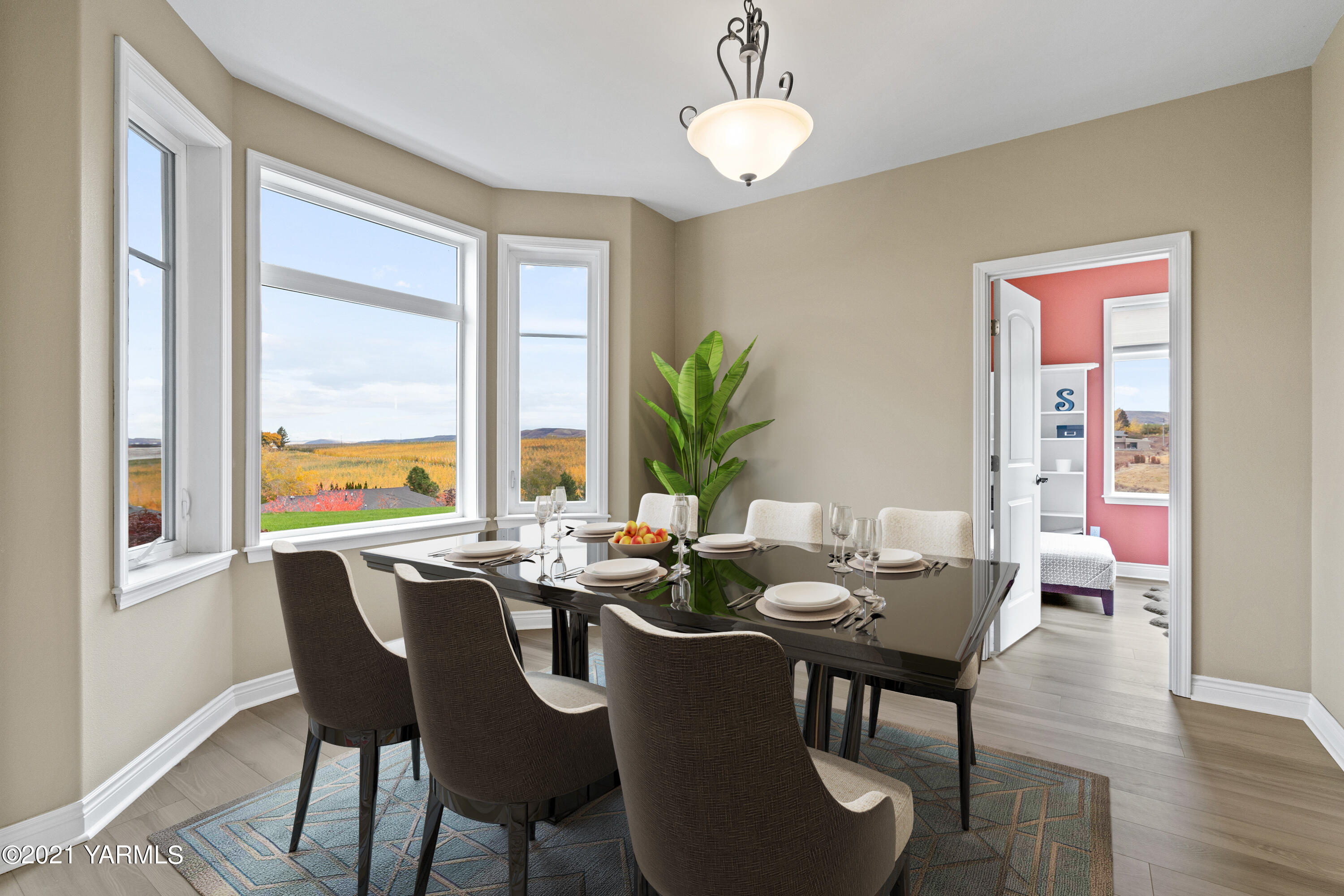 10807 Zier Road Yakima, WA 98908 - Photo 13 of 44 a dining room with furniture a chandelier and wooden floor