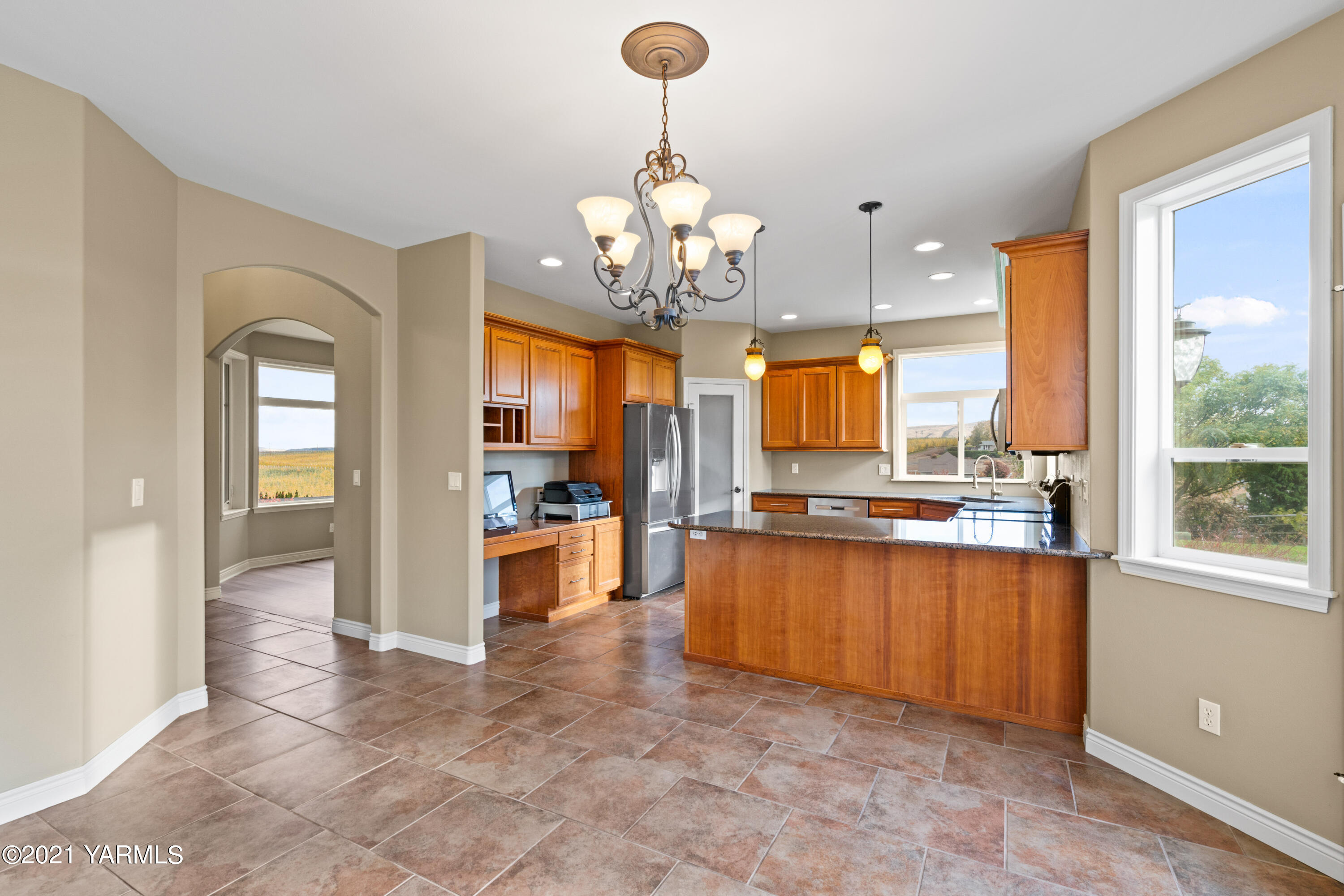 10807 Zier Road Yakima, WA 98908 - Photo 15 of 44 a view of a kitchen with granite countertop a large counter top a sink stainless steel appliances and cabinets