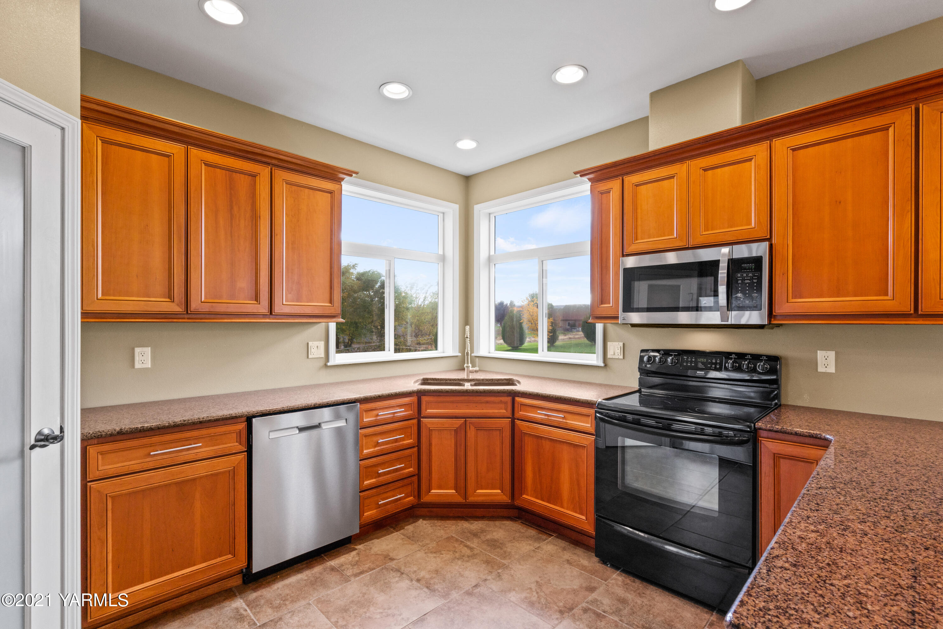 10807 Zier Road Yakima, WA 98908 - Photo 17 of 44 a kitchen with stainless steel appliances granite countertop a stove sink and microwave