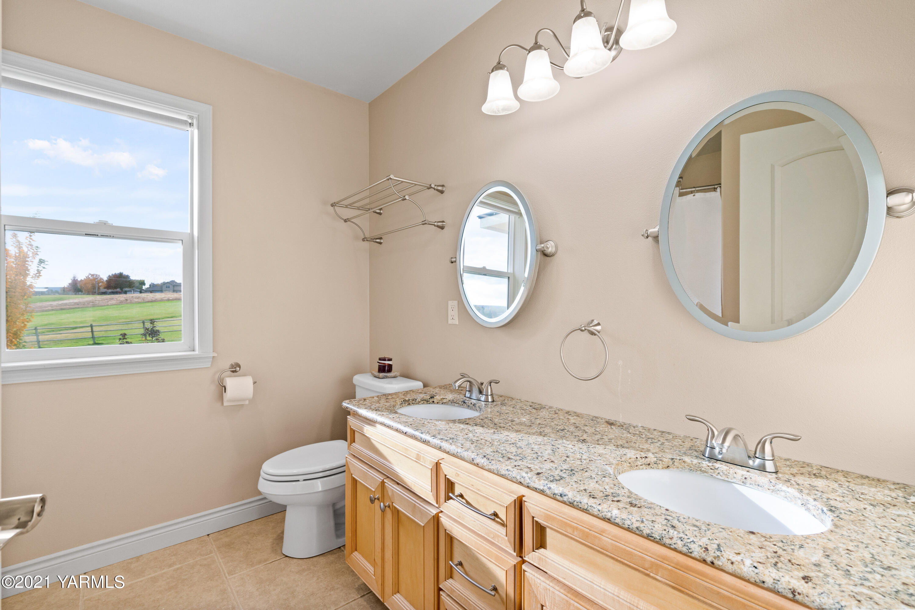 10807 Zier Road Yakima, WA 98908 - Photo 25 of 44 a bathroom with a granite countertop double vanity sink and a mirror