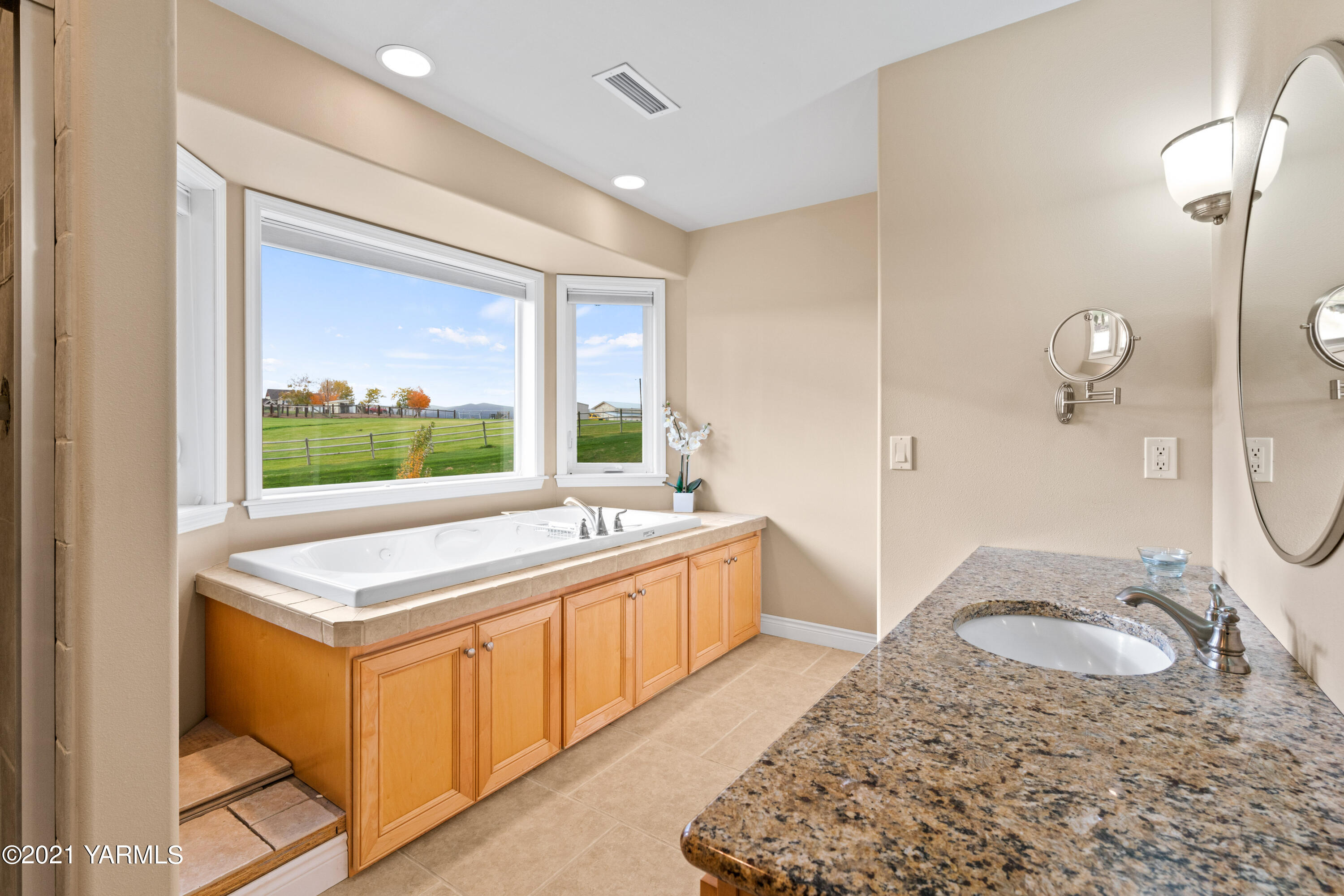 10807 Zier Road Yakima, WA 98908 - Photo 31 of 44 a bathroom with a granite countertop sink and mirror