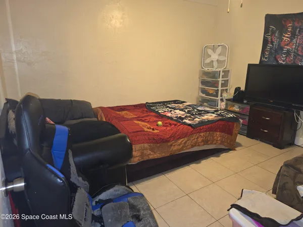 a bedroom with a bed and a desk
