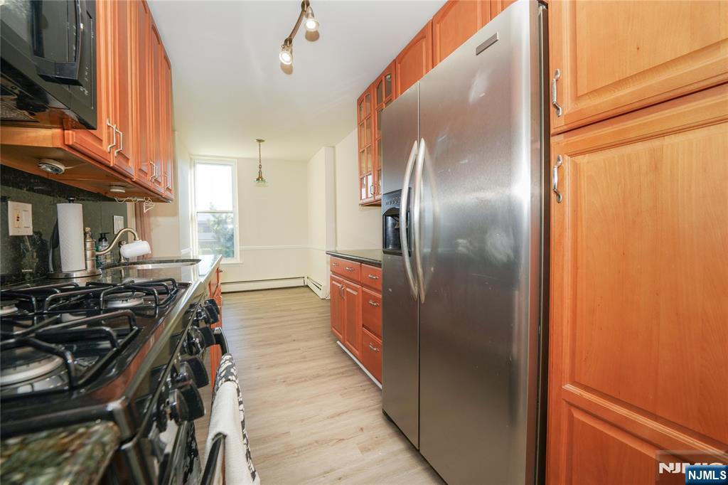 1 River, Unit 3G Nutley, NJ 07110 - Photo 14 of 27 a kitchen with stainless steel appliances granite countertop a refrigerator and a stove
