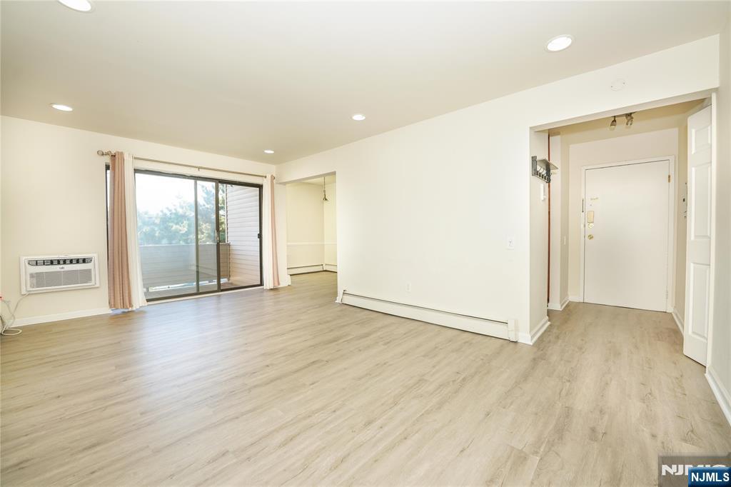 1 River, Unit 3G Nutley, NJ 07110 - Photo 6 of 27 a view of an empty room with wooden floor and a window