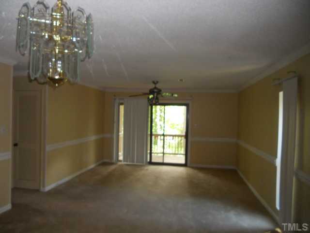654 Pine Ridge Place Raleigh, NC 27609 - Photo 2 of 7 en empty room with windows and chandelier