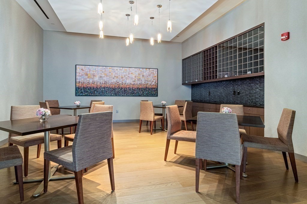 580 Washington Street, Unit 1207 Boston, MA 02111 - Photo 12 of 16 a view of a dining room with furniture