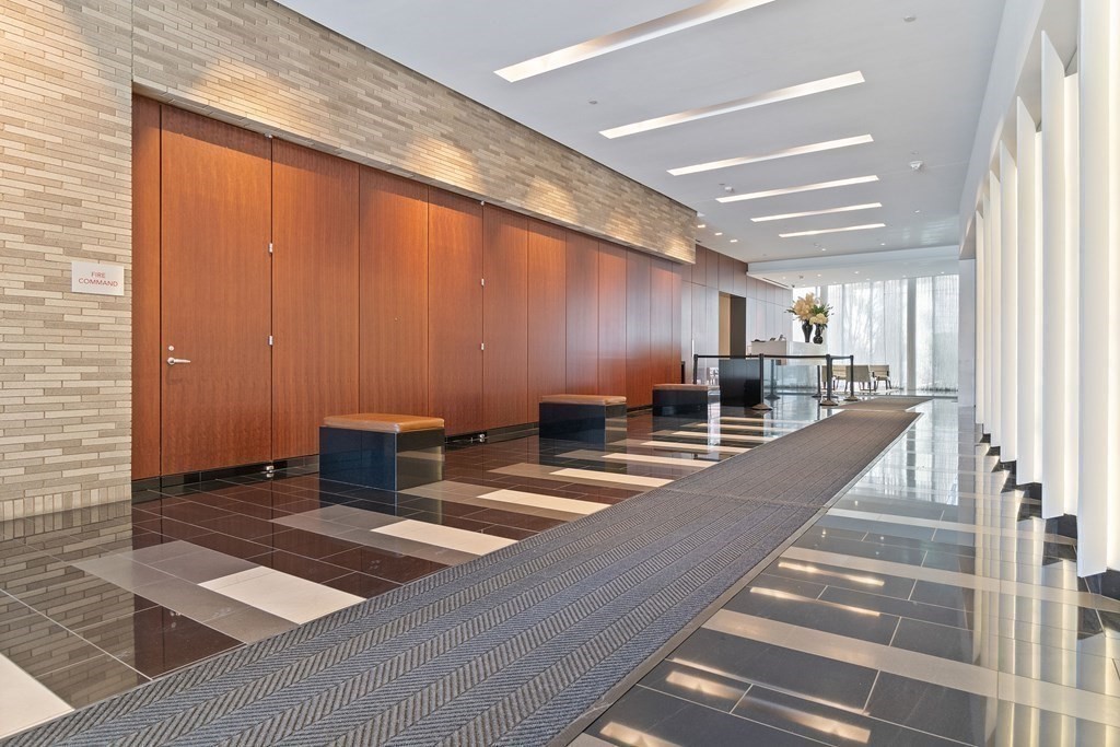 580 Washington Street, Unit 1207 Boston, MA 02111 - Photo 15 of 16 a view of a hall with stairs