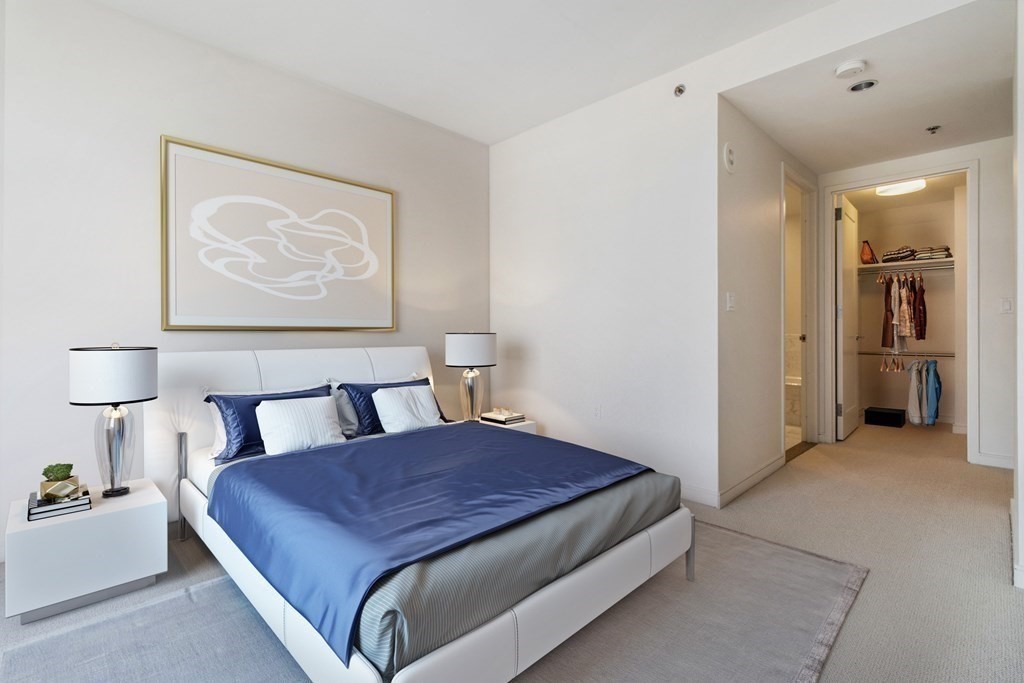 580 Washington Street, Unit 1207 Boston, MA 02111 - Photo 4 of 16 a spacious bedroom with a bed and cabinet