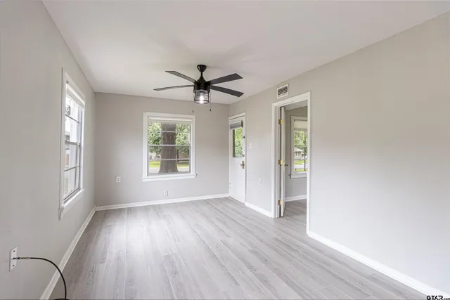 wooden floor in an empty room with a window