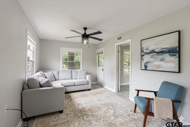 a living room with furniture and a large window