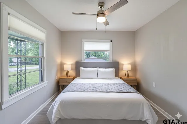 a bedroom with a large bed and a window