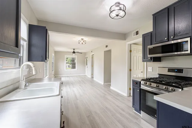a kitchen with granite countertop a stove and a refrigerator