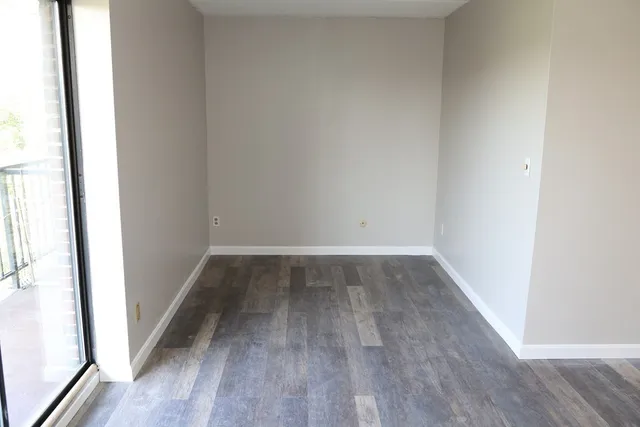 a view of a room with wooden floor