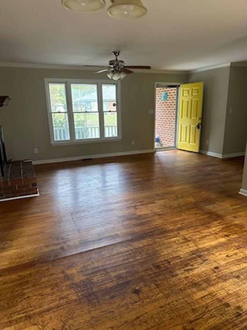 105 Starmount Road Clayton, NC 27520 - Photo 4 of 12 a view of an empty room with window and wooden floor