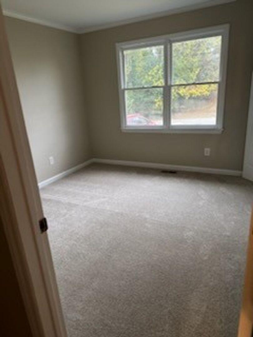 105 Starmount Road Clayton, NC 27520 - Photo 8 of 12 an empty room with a window