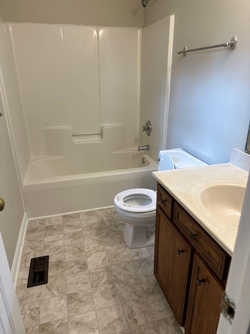 105 Starmount Road Clayton, NC 27520 - Photo 10 of 12 a bathroom with a sink a toilet and a bathtub