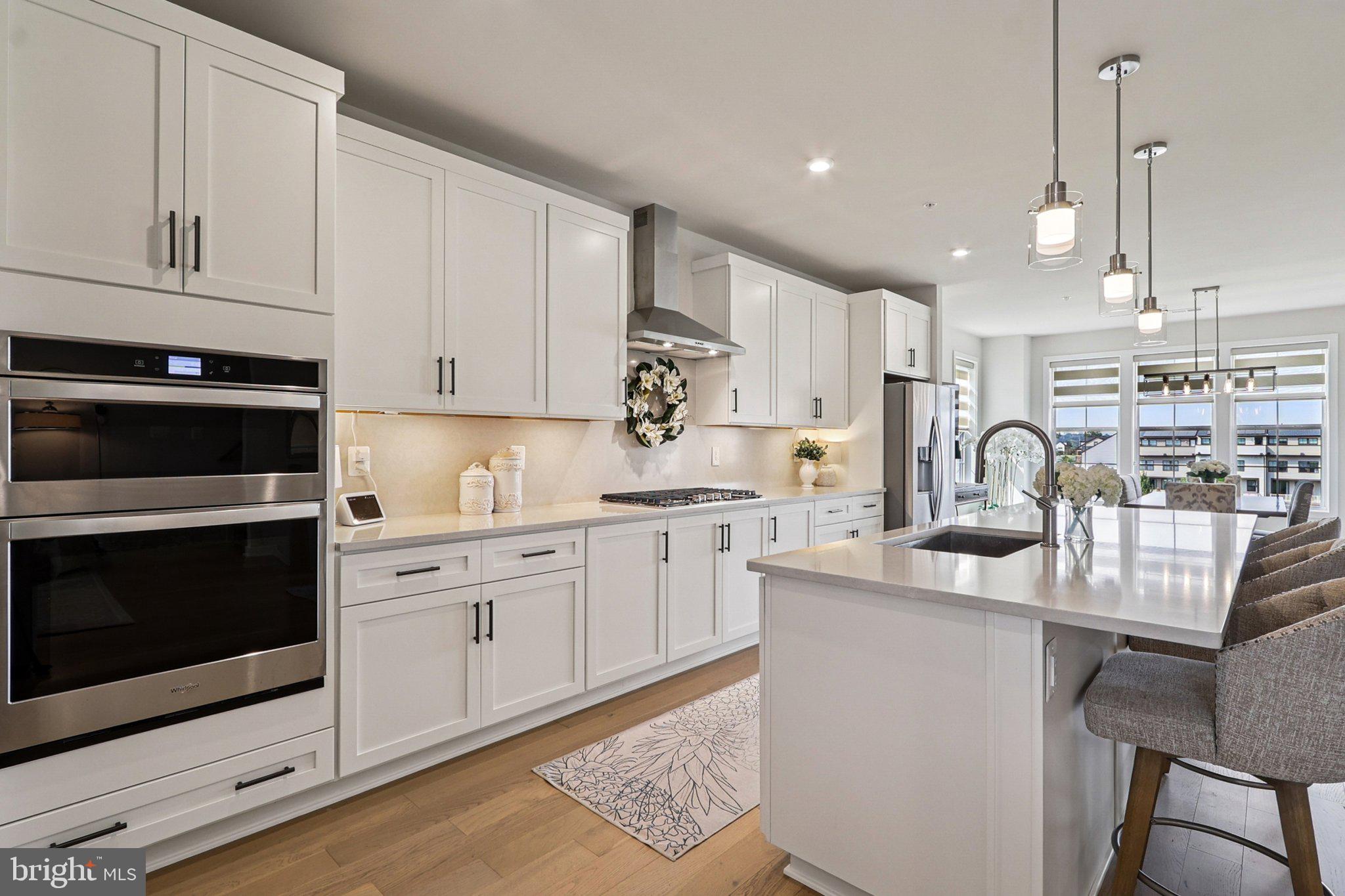 22381 Roanoke Rise Terrace Ashburn, VA 20148 - Photo 12 of 69 a kitchen with white cabinets stainless steel appliances and sink