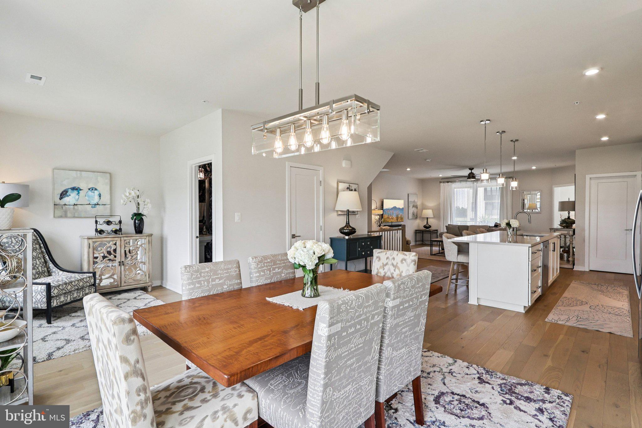 22381 Roanoke Rise Terrace Ashburn, VA 20148 - Photo 16 of 69 a living room with dining room and chandelier