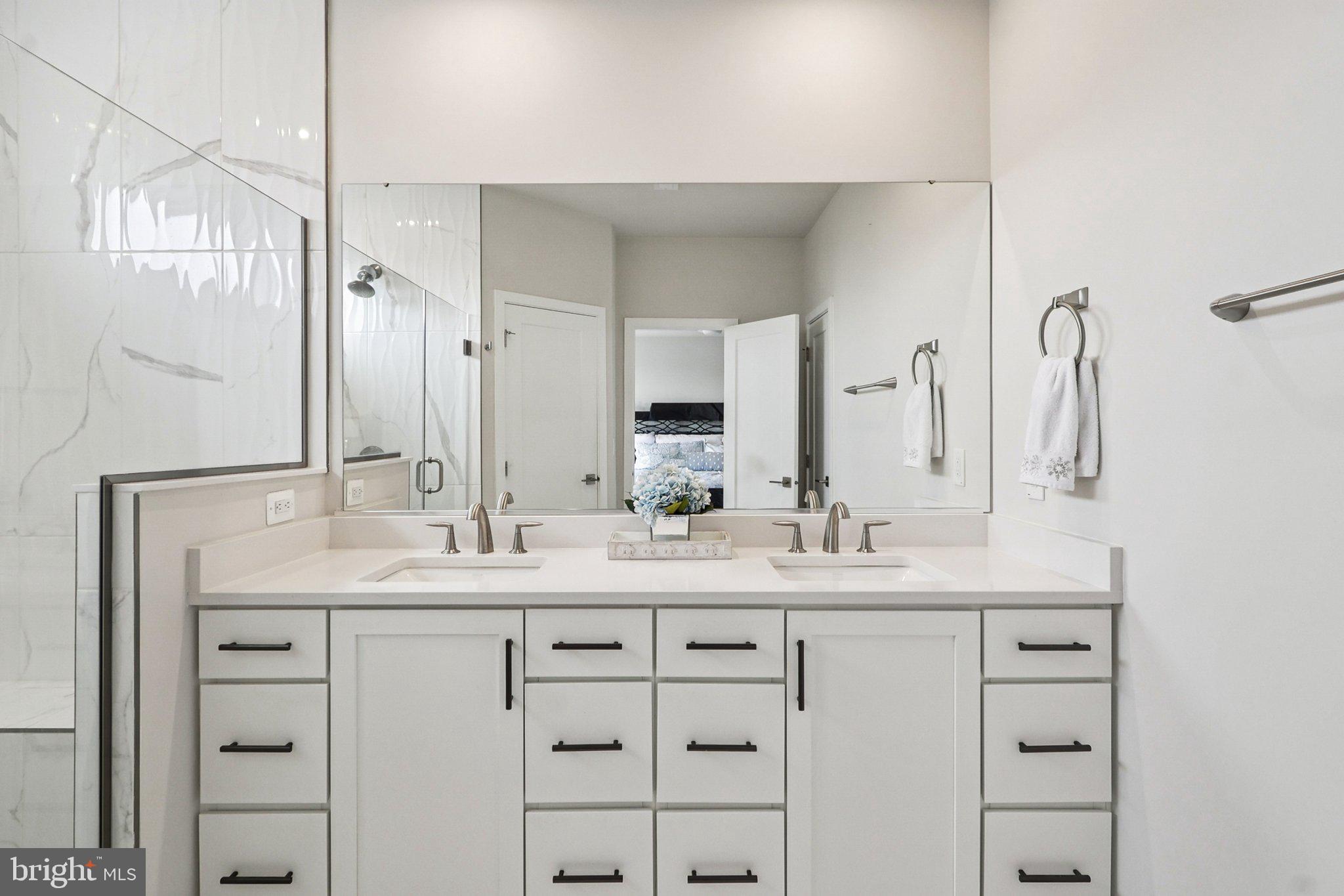 22381 Roanoke Rise Terrace Ashburn, VA 20148 - Photo 34 of 69 a bathroom with a double vanity sink mirror and double