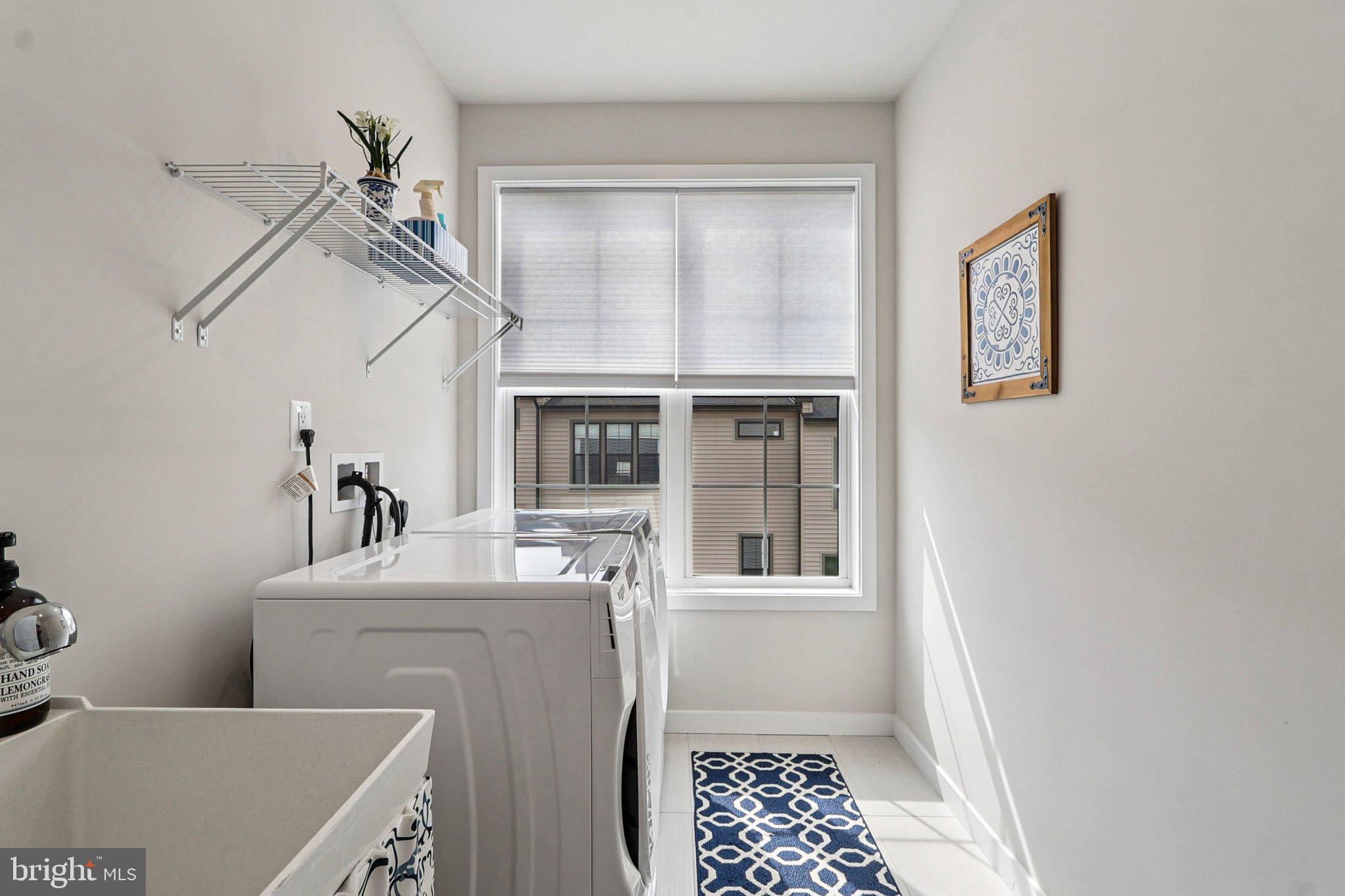 22381 Roanoke Rise Terrace Ashburn, VA 20148 - Photo 38 of 69 a room with a baby crib dryer and washer