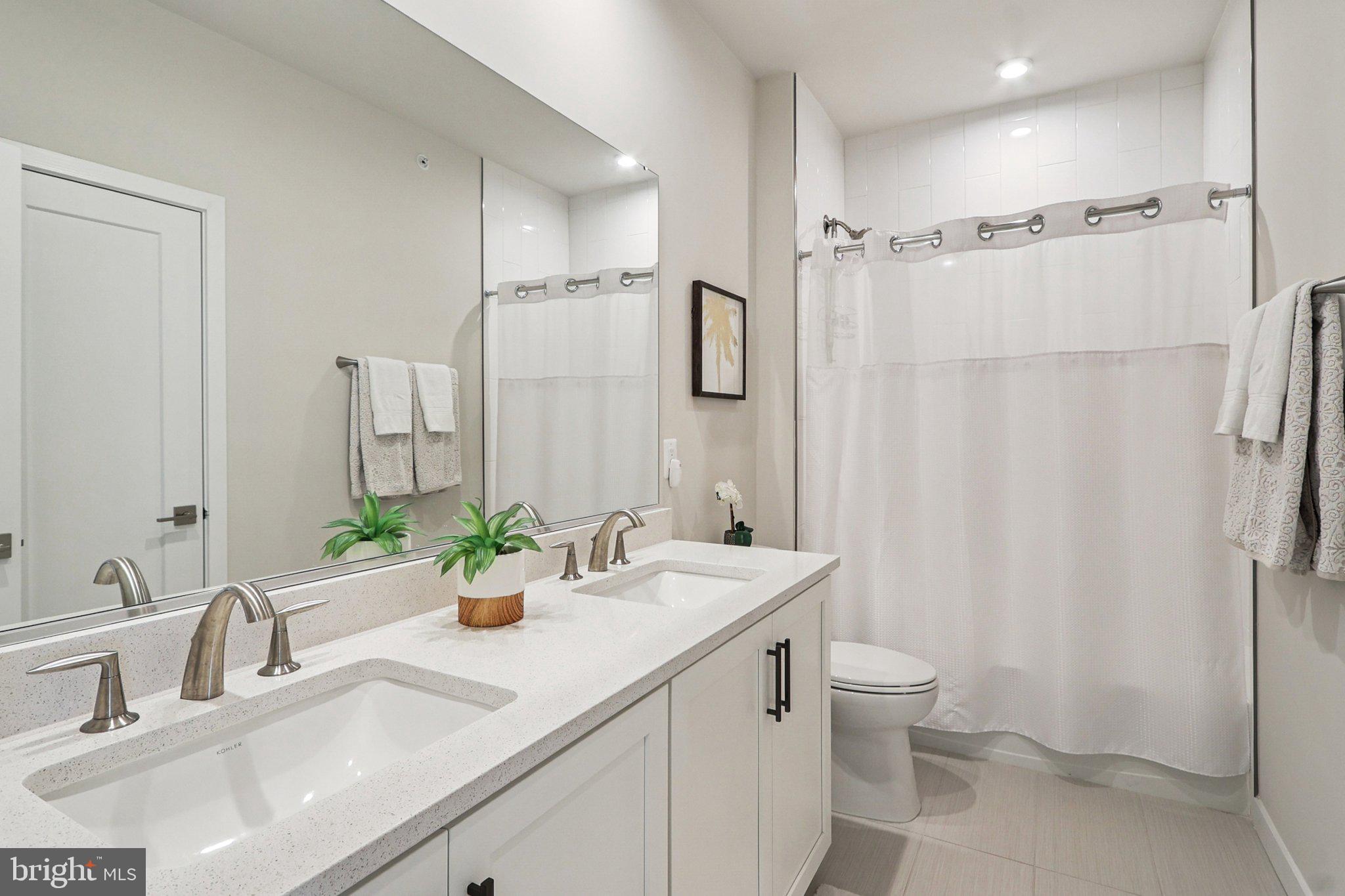 22381 Roanoke Rise Terrace Ashburn, VA 20148 - Photo 40 of 69 a bathroom with a double vanity sink toilet and shower