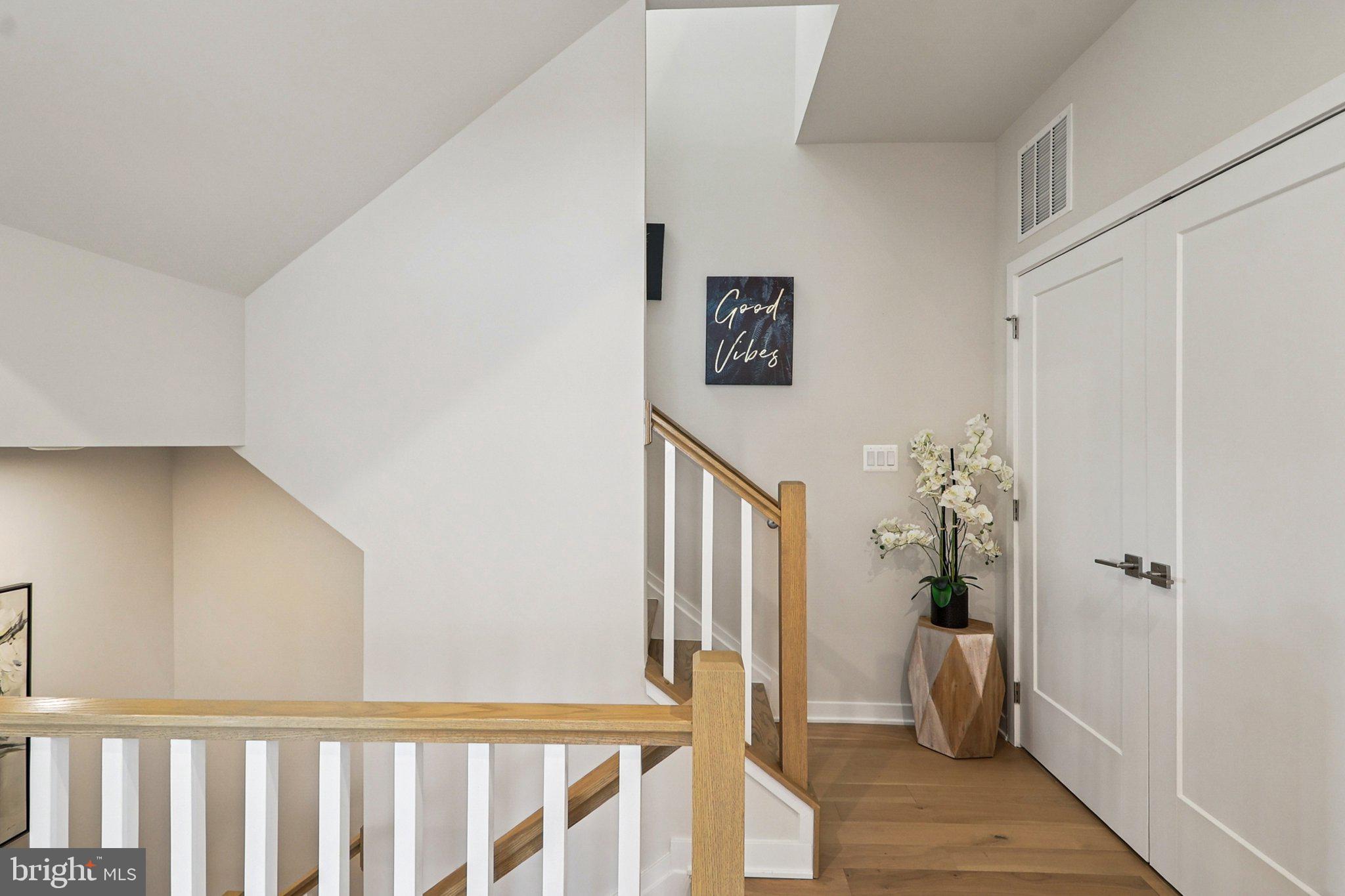 22381 Roanoke Rise Terrace Ashburn, VA 20148 - Photo 44 of 69 a view of a hallway with bathroom and wooden floor