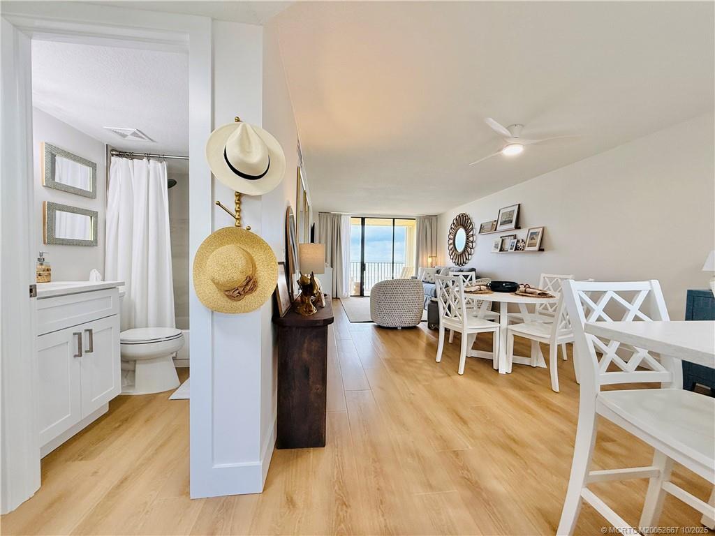 7370 South Ocean Drive, Unit 312 Jensen Beach, FL 34957 - Photo 13 of 67 a living room with furniture a mirror and kitchen view