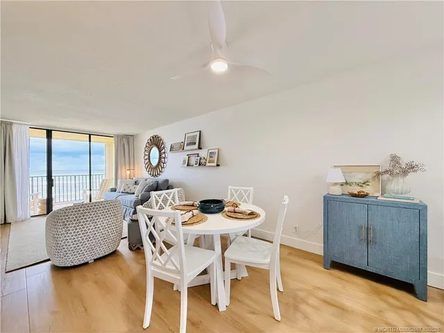 a dining room with furniture and a wooden floor