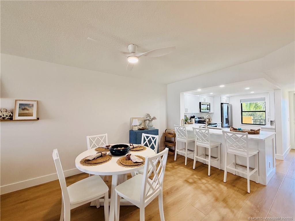 7370 South Ocean Drive, Unit 312 Jensen Beach, FL 34957 - Photo 15 of 67 a view of a dining room with furniture and wooden floor