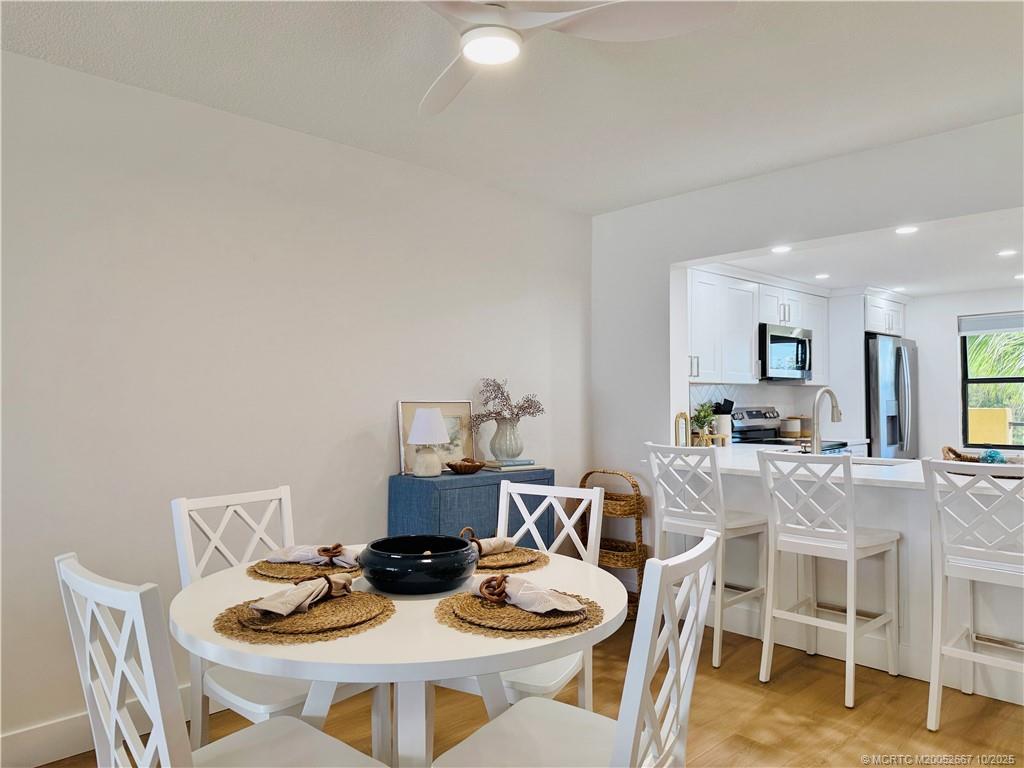 7370 South Ocean Drive, Unit 312 Jensen Beach, FL 34957 - Photo 16 of 67 a dining room with furniture and a wooden floor