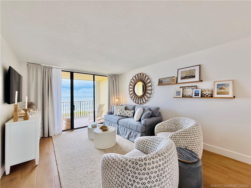 7370 South Ocean Drive, Unit 312 Jensen Beach, FL 34957 - Photo 24 of 67 a living room with furniture and a large window