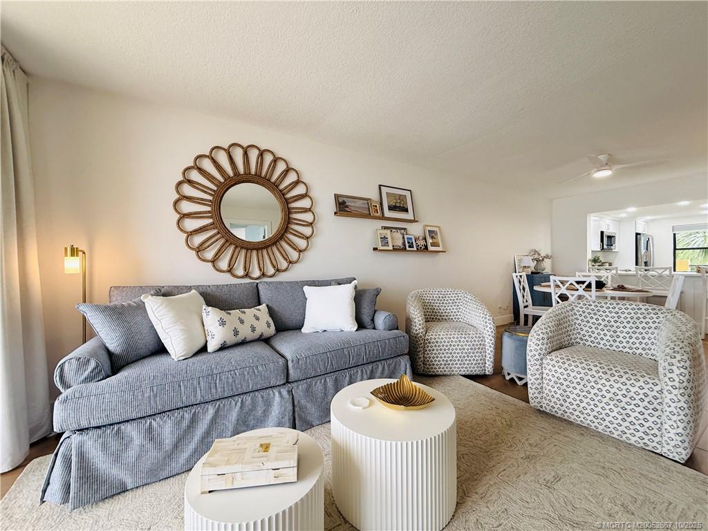 7370 South Ocean Drive, Unit 312 Jensen Beach, FL 34957 - Photo 26 of 67 a living room with furniture a rug and a lamp