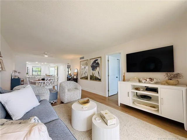a spacious bedroom with a bed and wooden floor