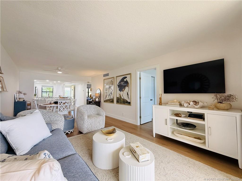 7370 South Ocean Drive, Unit 312 Jensen Beach, FL 34957 - Photo 28 of 67 a living room with furniture and a flat screen tv