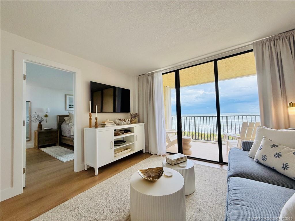7370 South Ocean Drive, Unit 312 Jensen Beach, FL 34957 - Photo 29 of 67 a living room with furniture and a flat screen tv