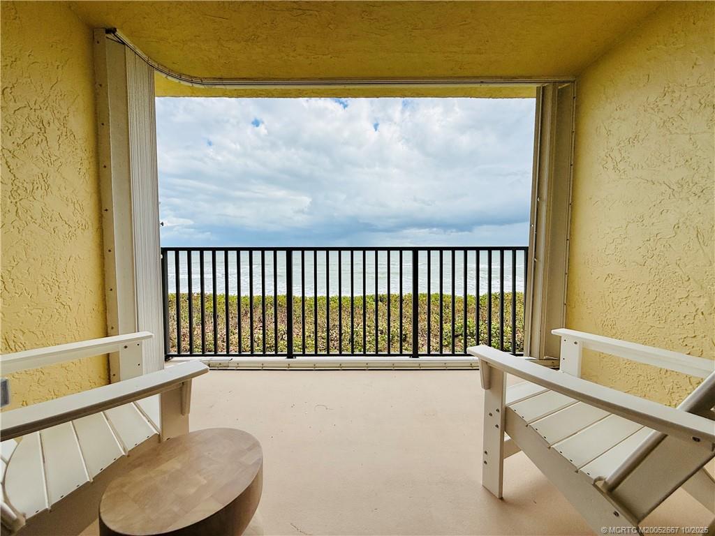 7370 South Ocean Drive, Unit 312 Jensen Beach, FL 34957 - Photo 31 of 67 a view of a chair and table in a balcony